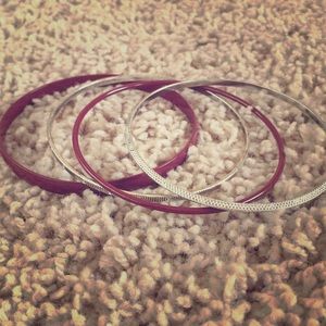 Four Black and Sliver Bracelets.